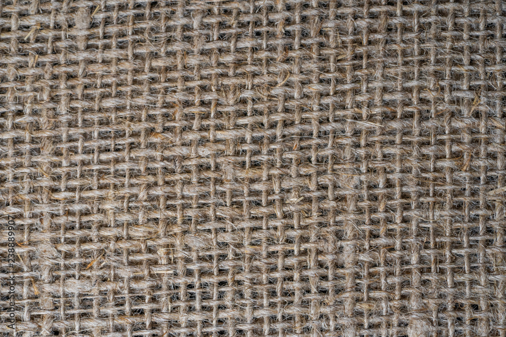 The texture of burlap. Rough background close up. The texture of burlap. Rough background close up.