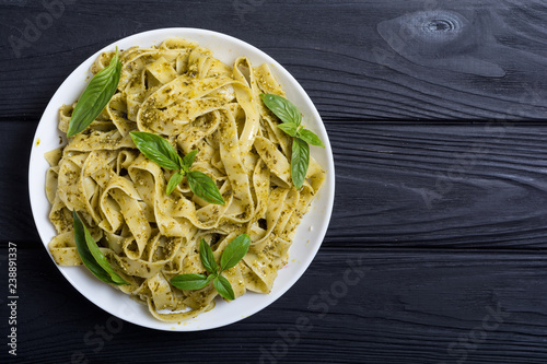 Pasta tagliatelle with green sauce pesto . Italian food background photo