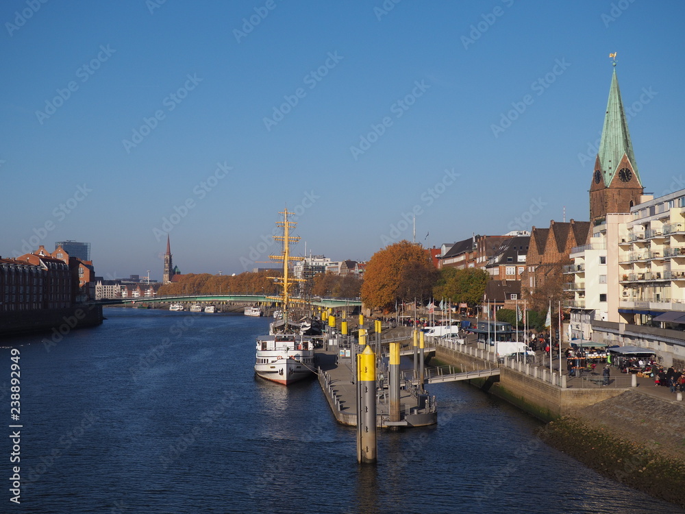 Bremen, Germany - View of the river Weser and the historic Schlachte waterfront with the spire of St. Martini church Bremen, Germany - View of the river Weser and the historic Schlachte waterfront with the spire of St. Martini church