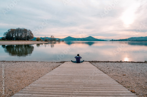 Man sitting taking pictures to the reservoir of Ullibarri-Gamboa. Alava, Basque Country, Spain