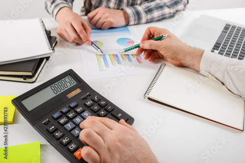 Business concept. Two business mans working and meeting with chart at office on his desk.