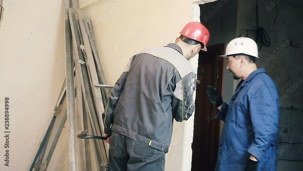 Builder and Manager checking colleagues work Builder and Manager checking colleagues work
