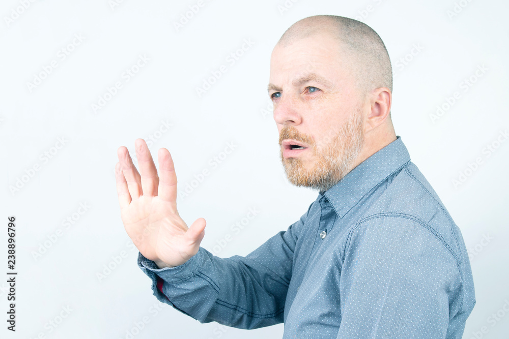 Bearded man puts forward an open hand