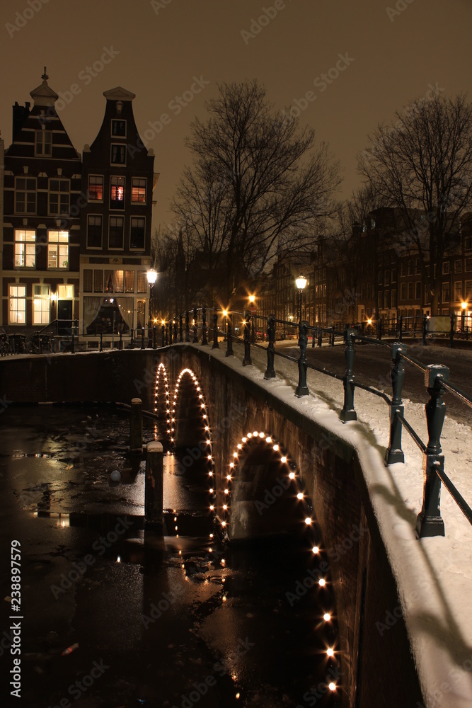 Amsterdam covered in snow at night