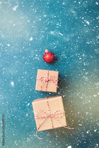 Gift boxes wrapped in kraft paper and tied with candy cane Christmas rope and...