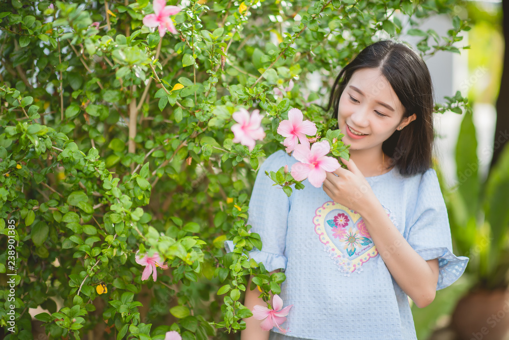 Beautiful asian young bride outdoors in a forest. Pretty Thai girl in garden.
