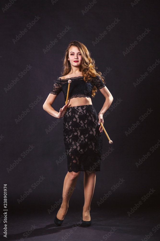 Portrait of a girl with drum sticks on a black background Portrait of a girl with drum sticks on a black background