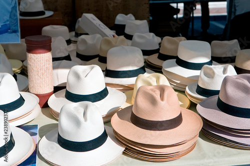 White and brown hats in rows on the market in Spain