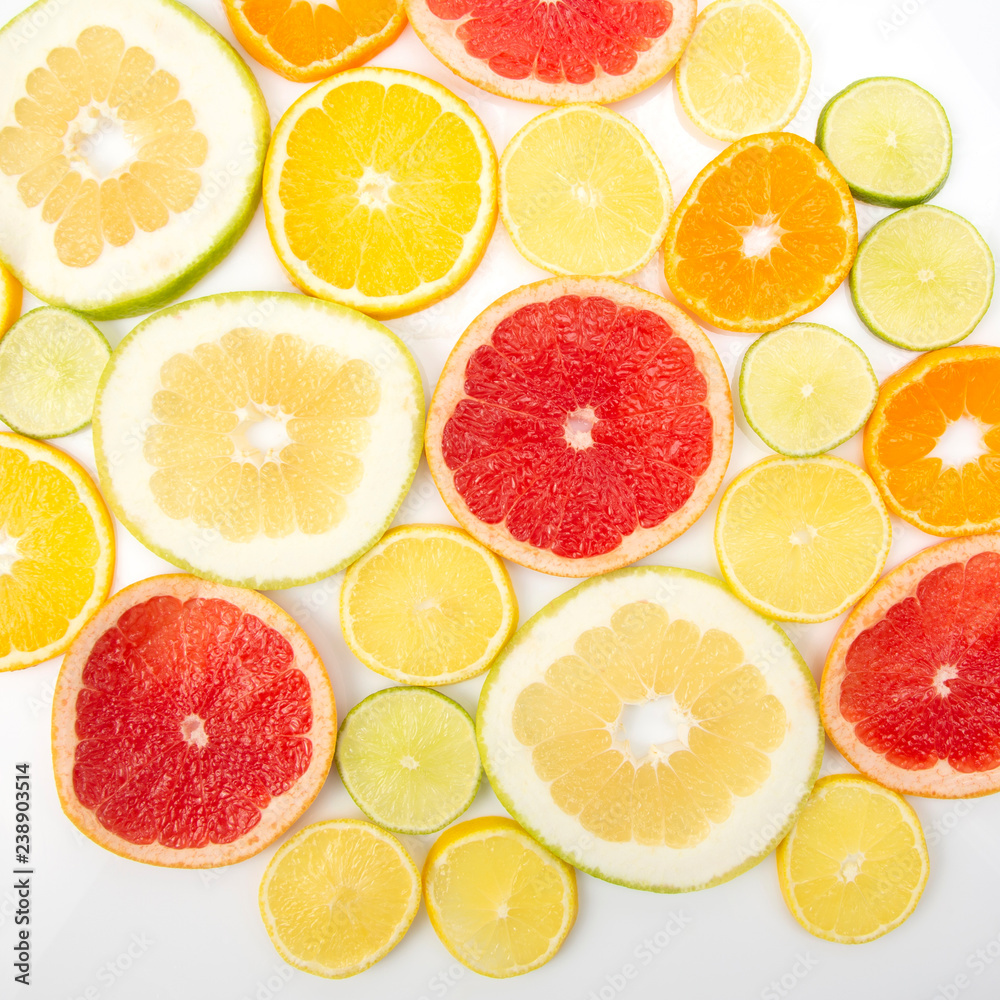 cut pieces of different citrus fruits on white background cut pieces of different citrus fruits on white background