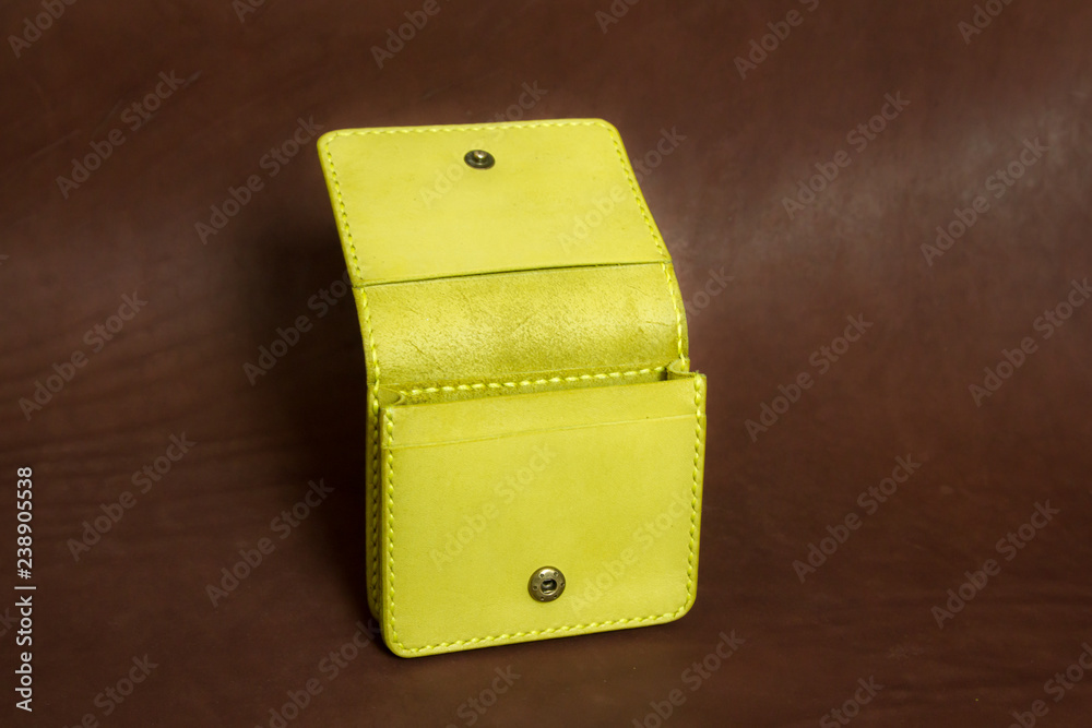 wallet yellow on a brown background wallet yellow on a brown background