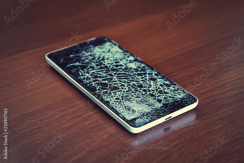 Black smartphone with broken screen photo