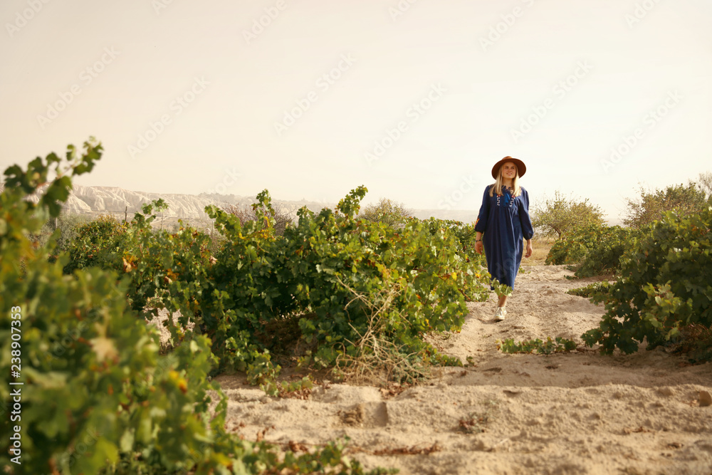 Obraz premium Nature. Woman In Vineyard Field Between Green Bushes