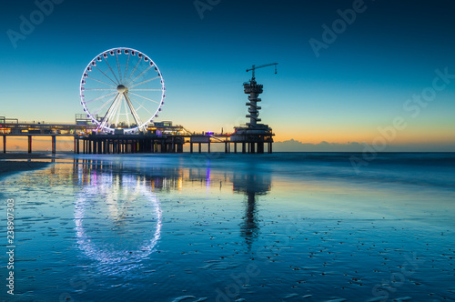 ferris wheel on the Pier at Scheveningen at sunset photo