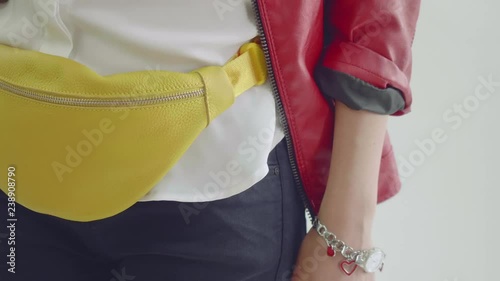 Yellow fanny pack is on hips of model. Photo session of fashionable fanny pack.