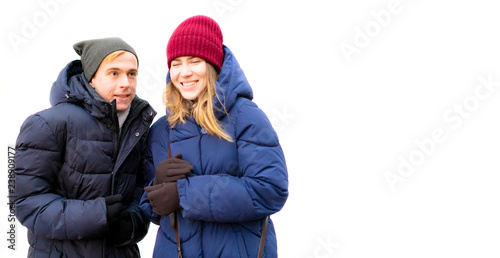 young couple feeling cold and frozen outdoors isolated in white background on a cold winter day and warm up f