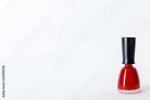 bottle of bright red nail polish on white © LIGHTFIELD STUDIOS