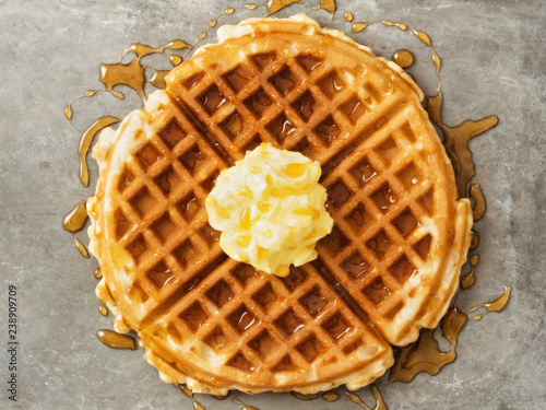 rustic traditional waffle with butter and maple syrup
