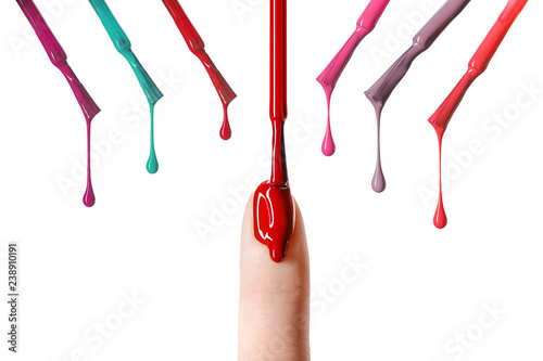 messy drop of red nail polish dripping  on nail isolated on white photo
