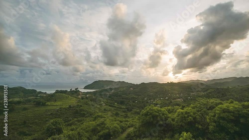 Sunset and moving clouds over the valley and beach in Kuta Lombok Indonesia in a 4K time-lapse photo