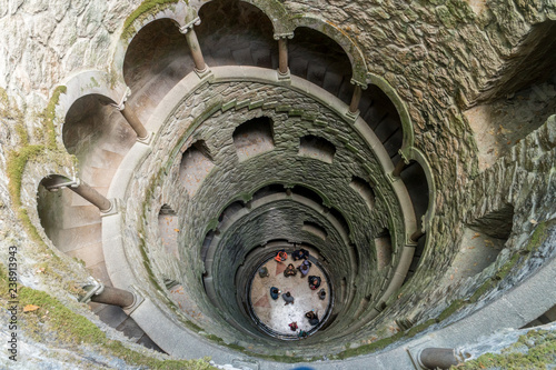 People visiting The Initiation well of Quinta da Regaleira in Sintra, Portugal. photo