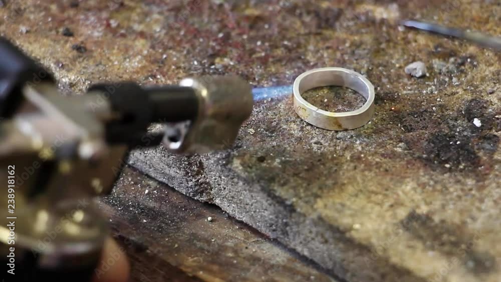transfer focus from piece of silver solder to billet for ring with burner, workshop jewelry transfer focus from piece of silver solder to billet for ring with burner, workshop jewelry
