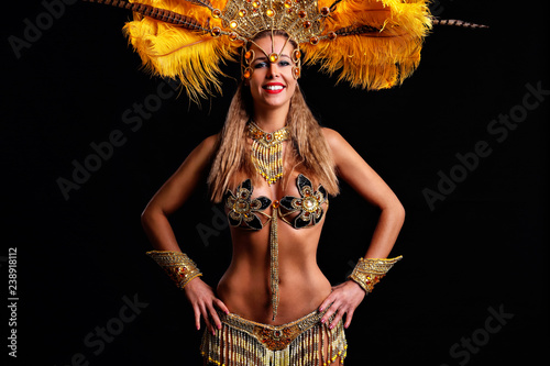 Brazilian woman posing in samba costume over black background