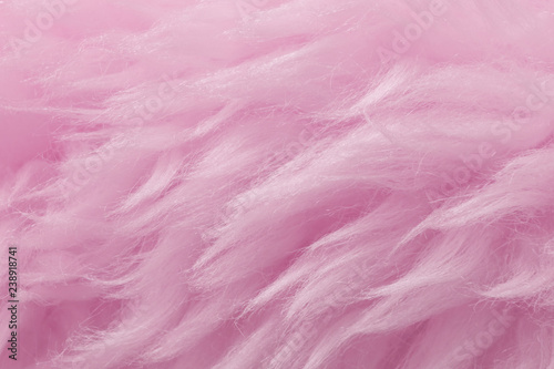 Pink animal wool texture background. Rosy tint natural wool. Close-up texture of plush fluffy fur