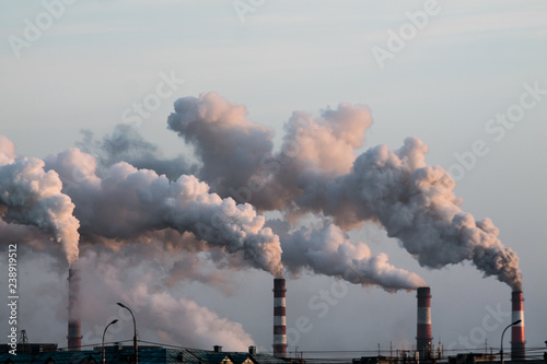 industrial chimneys with heavy smoke causing air pollution