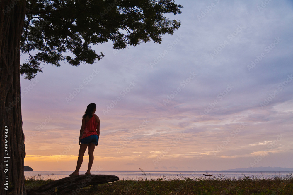 girl watching sunset at costa rica beach