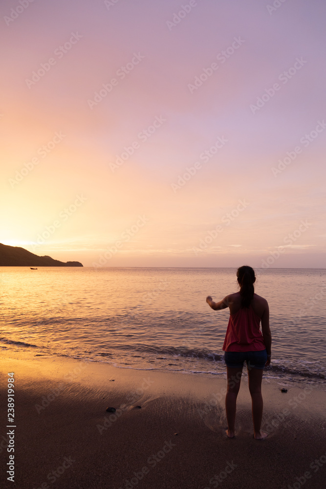 girl watching sunset at costa rica beach