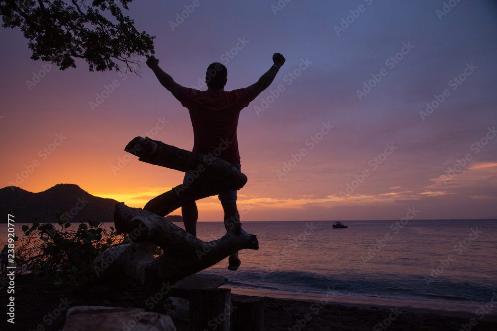 man watching sunset at costa rica beach man watching sunset at costa rica beach