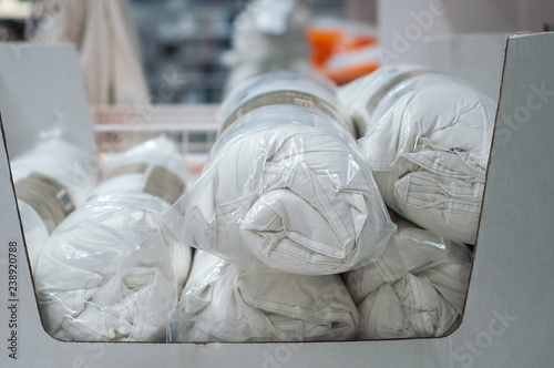 closeup of white set of bed linen rolls in decoration store