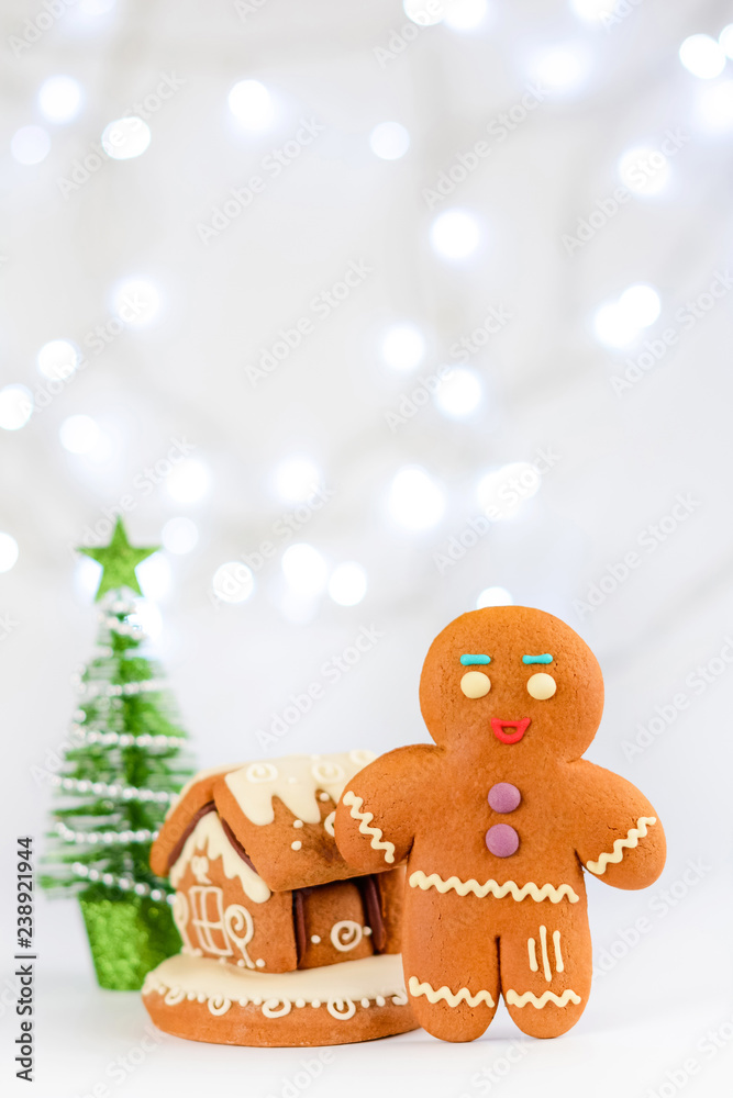 Gingerbread man near the house. Christmas food decoration.