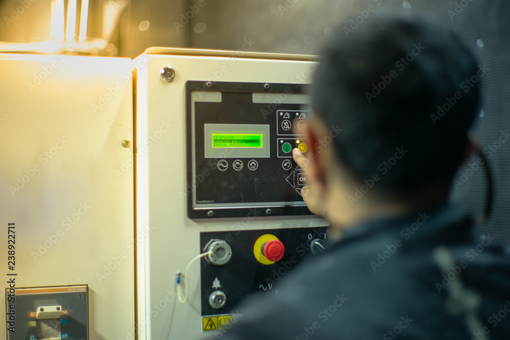 Blurred portrait of technician doing the preventive maintenance in the control room. Workers monitoring the status of electronic devices by check list. Blurred portrait of technician doing the preventive maintenance in the control room. Workers monitoring the status of electronic devices by check list.