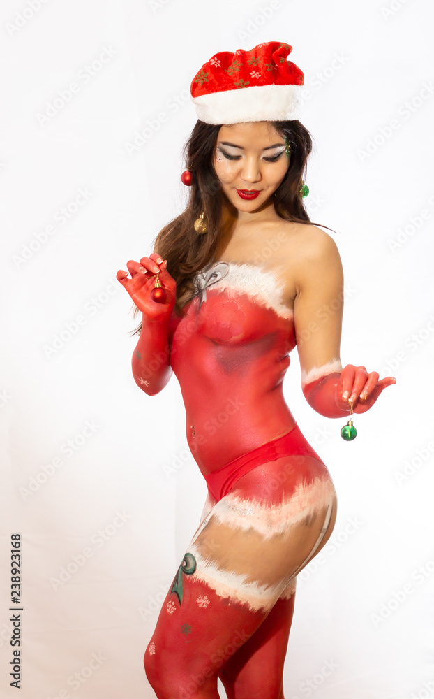 Christmas body painting on a sexy Asian girl in the form of New Year's underwear. Christmas body painting on a sexy Asian girl in the form of New Year's underwear.