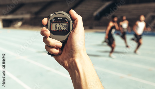 Obraz na płótnie Man keeping time at a running race using stop watch