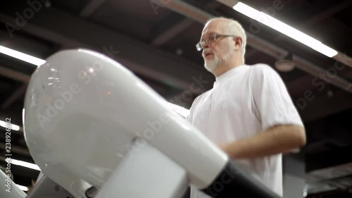 Elderly man has a treadmill