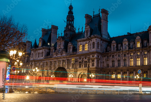 view of an old building in paris in the morning amid cars