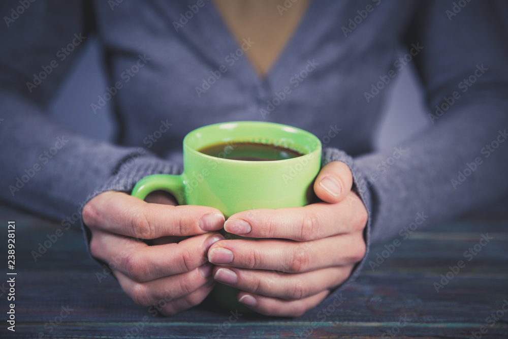 Woman holds a cup of hot tea. Cozy morning at home. Woman holds a cup of hot tea. Cozy morning at home.