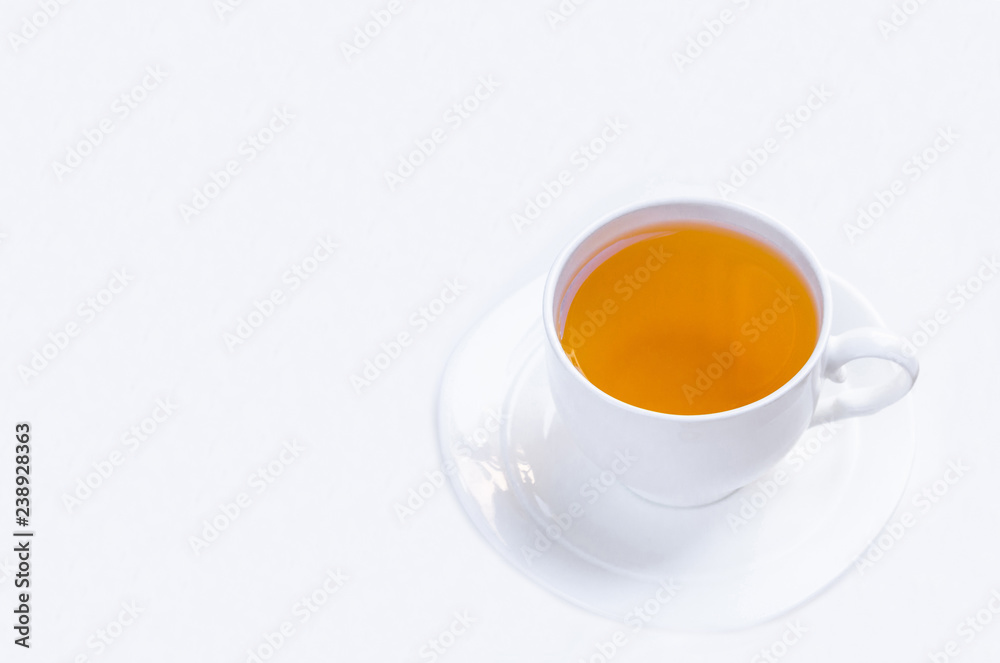 Orange herbal flavored christmas tea with cinnamon and cardamom honey white cup on a white wooden table Orange herbal flavored christmas tea with cinnamon and cardamom honey white cup on a white wooden table