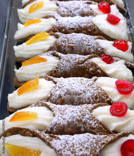 Sicilian pastries called cannoli stuffed with ricotta and candie photo