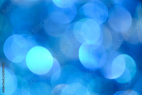 Bokeh photo. Holiday background. Christmas lights. background. Defocused sparkles. New Year backdrop. Festive wallpaper. Blinks. Carnival. Retro style photo. Blue.