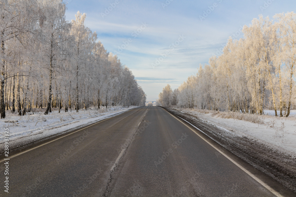 Winter road in a frozen forest Winter road in a frozen forest