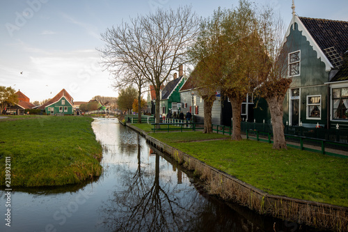 Typical labour house in the countryside of the province of Holland with a drench with a bridge connecting it to the passing road and other patches