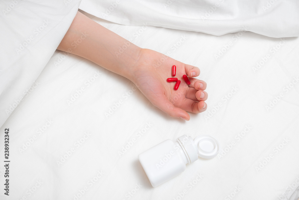 Woman hand with lot of drugs in the bed Woman hand with lot of drugs in the bed