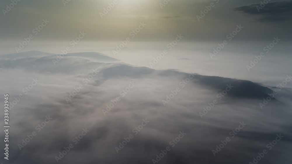Aerial view from a drone about the Transylvanian valleys on a foggy morning, above Sic village, Transylvania, Romania Aerial view from a drone about the Transylvanian valleys on a foggy morning, above Sic village, Transylvania, Romania