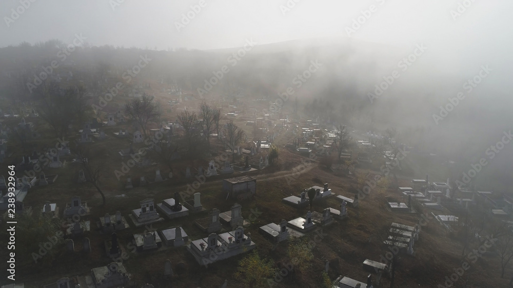 Aerial view  about the cemetery on a foggy morning In Sic village, Transyvania, Romania