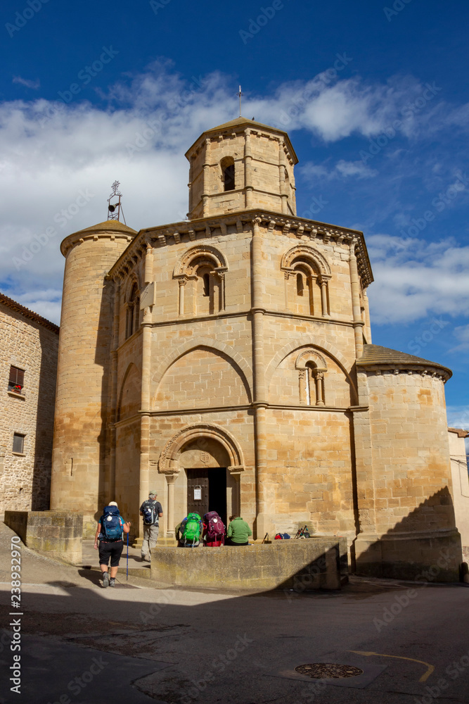 Pilgrims in front of the Church of Santo Sepulcro, Church of the Holy Sepulchre in Torres del Rio, Navarre Spain on the Way of St. James, Camino de Santiago