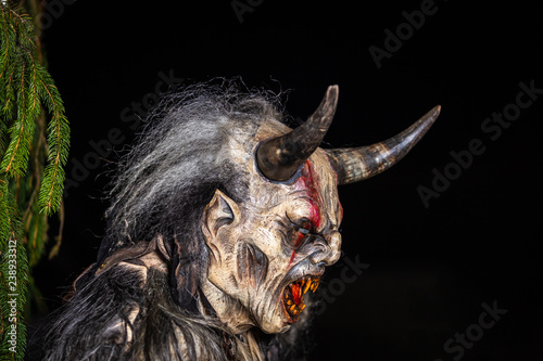 фотографія Closeup on horned devil in traditional krampuslauf with wooden masks in Retz, Austria
