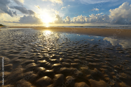 Reflection of sunrise beach